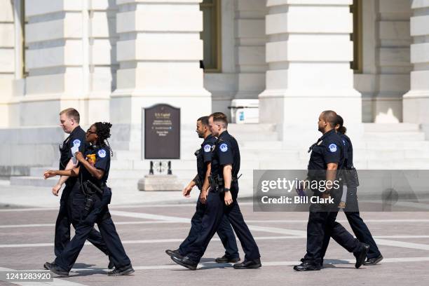 Squad of U.S. Capitol Police officers walks across the East Plaza of the U.S. Capitol on Monday morning, June 13, 2022.