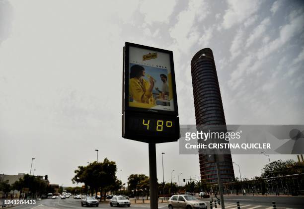 Street thermometer reads 48 degrees Celsius during a heatwave in Seville on June 13, 2022. - Spain was today already in the grips of a heatwave...