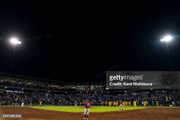 During the seventh inning, fans turn on their cellphone lights and sign Coldplays Yellow during a game against the Kansas City Monarchs at Legends...