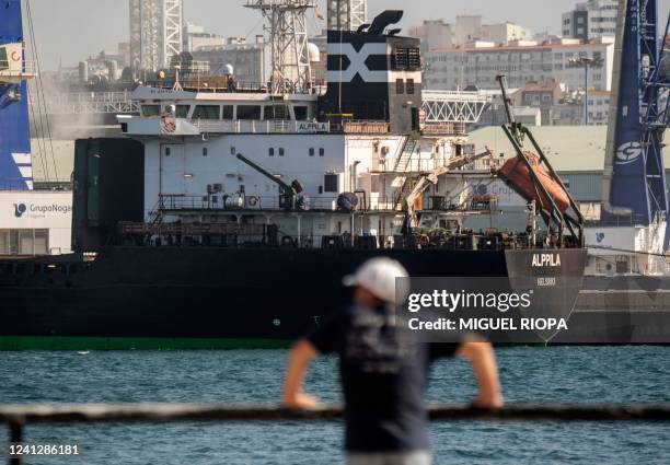 Finnish cargo-ship Alppila, carrying 18,000 tonnes of grain for animals from Ukraine, is unloaded at the port of A Coruna, on June 13, 2022. - A...