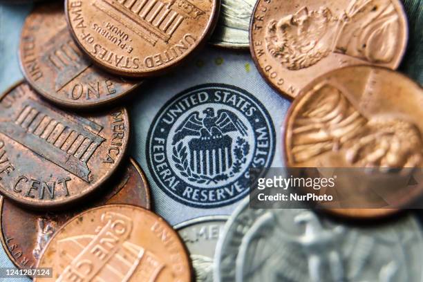 Seal of the United States Federal Reserve System on a banknote is seen with coins in this illustration photo taken in Krakow, Poland on June 13, 2022.