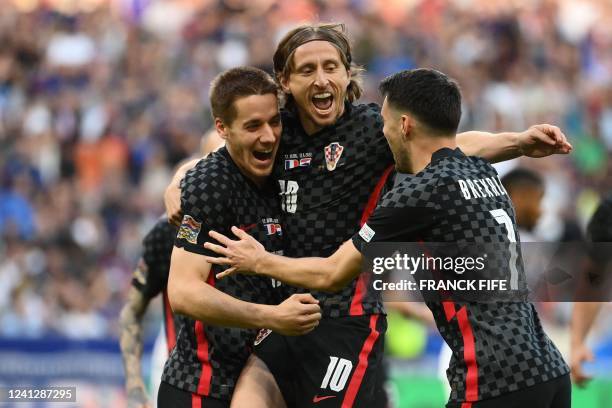 Croatia's midfielder Luka Modric celebrates his team's first goal with teammates during the UEFA Nations League - League A Group 1 football match...