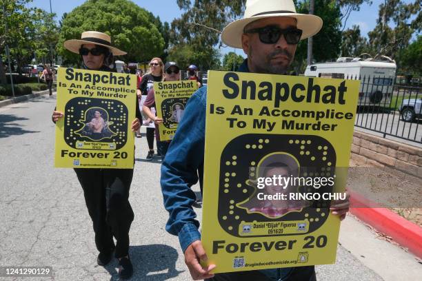 People opposed to the sale of illegal drugs on Snapchat participate in a rally outside the company's headquarters to call for tighter restrictions on...