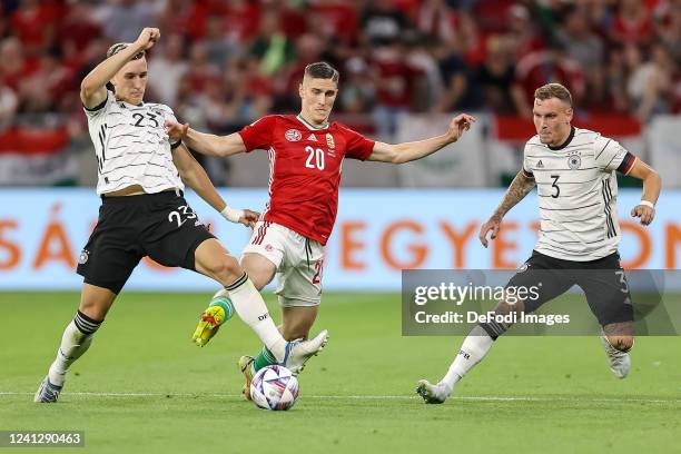 Nico Schlotterbeck of Germany, Roland Sallai of Hungary and David Raum of Germany battle for the ball during the UEFA Nations League League A Group 3...