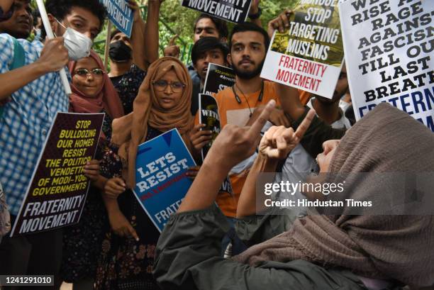 Activists of Fraternity movement, Students Islamic Organisation of India and others hold placards and protest against the Bulldozer action and...