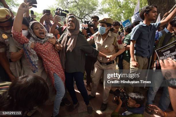 Activists of Fraternity movement, Students Islamic Organisation of India and others being detained by police personnel during a protest against the...