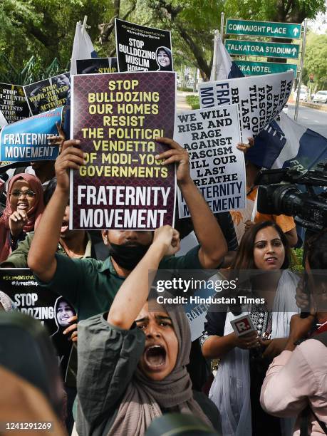 Activists of Fraternity movement, Students Islamic Organisation of India and others hold placards and protest against the Bulldozer action and...