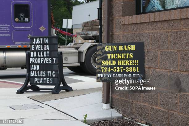 Signs seen outside of the Army & Navy store in downtown Latrobe advertise bulletproof vests, ballistic plates, and gun bash tickets. The store sells...