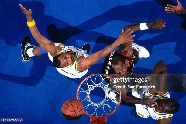 Mario Elie of the Golden State Warriors goes for the rebound against Clyde Drexler of the Portland Trail Blazers during a game in 1992 at The...