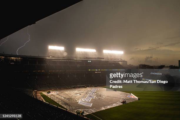 Lightning strikes over the ballpark during a weather delay before the San Diego Padres play against the Chicago Cubs on June 13, 2022 at Wrigley...