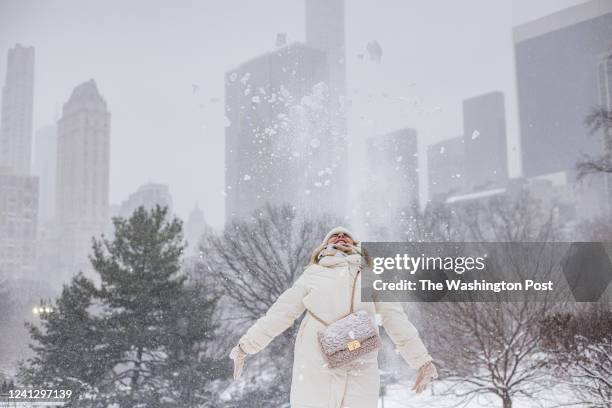 Woman plays in snow at Central Park during a Nor'easter storm in Manhattan on January 29, 2022.