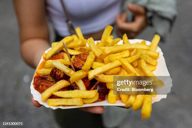 Serving of 'Currywurst', a German street food of sausage and spiced ketchup, arranged in the Victuals Market in Munich, Germany, on Saturday, June...