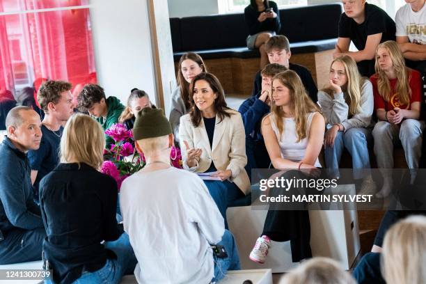 Crown Princess Mary of Denmark sits among participants as she visits a project of The Mary Foundation developed for students in after-school care...