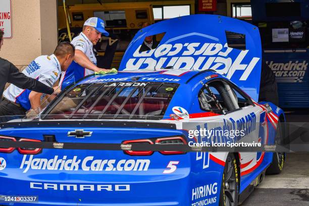 Team crew members work on final preparations for Kyle Larson driving a Chevrolet for Hendrick Motorsports sponsored by HendrickCars.com before the...