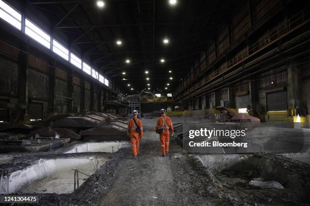 Workers walk between cooling ingots of Bessemer matte at the Vale Copper Cliff Smelter Complex in Sudbury, Ontario, Canada, on Wednesday, June 1,...