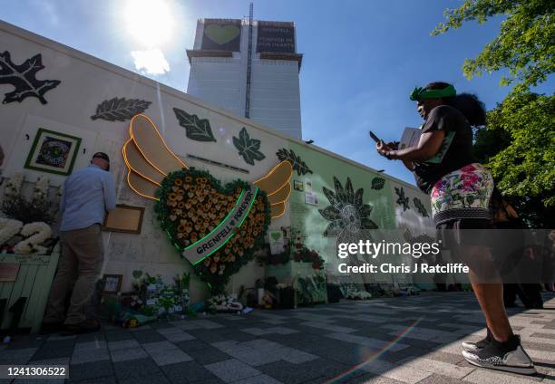 People view tributes left to the victims of the Grenfell Tower fire at Grenfell Tower on June 14, 2022 in London, England. On 14 June 2017, just...