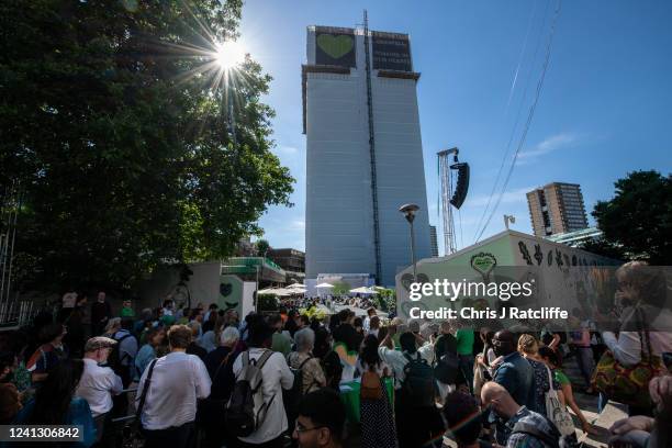 Crowds gather to watch a memorial service at Grenfell Tower on June 14, 2022 in London, England. On 14 June 2017, just before 01:00, a fire broke out...