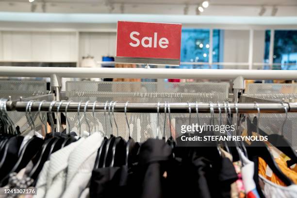 Sale sign is displayed in a clothing store in Washington, DC, on June 14, 2022