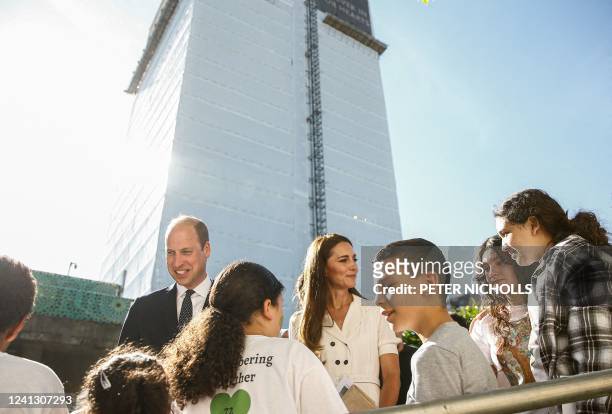 Britain's Prince William, Duke of Cambridge and Britain's Catherine, Duchess of Cambridge speak with survivors and bereaved children at a memorial...