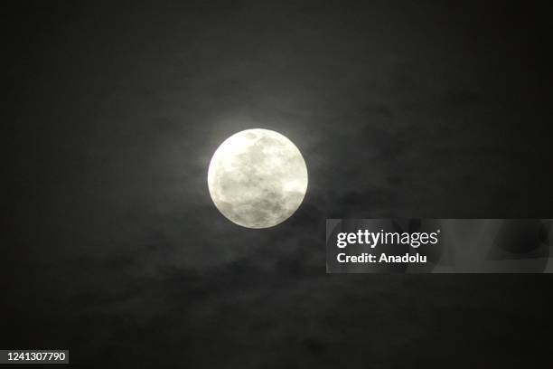 The Full Moon, known as the Strawberry Moon rises over the sky in Banten, Indonesia on June 14, 2022.