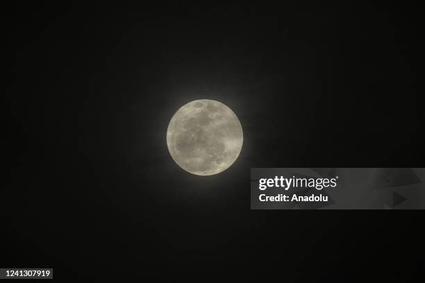 The Full Moon, known as the Strawberry Moon rises over the sky in Banten, Indonesia on June 14, 2022.