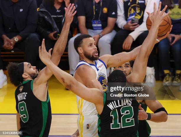 San Francisco Golden State Warriors guard Stephen Curry makes layup beating Boston Celtics forward Grant Williams and guard Derrick White during...