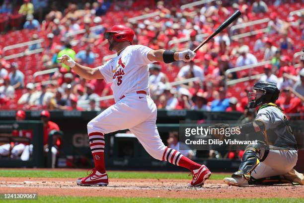 Albert Pujols of the St. Louis Cardinals hits a single against the Pittsburgh Pirates in the second inning during game one of a doubleheader at Busch...