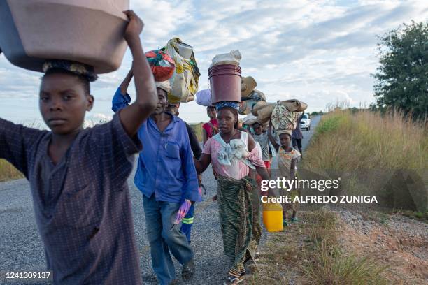 Displaced families from the community of Impire, a town in the district of Metuge in the Cabo Delgado province, flee on June 14, 2022 armed...