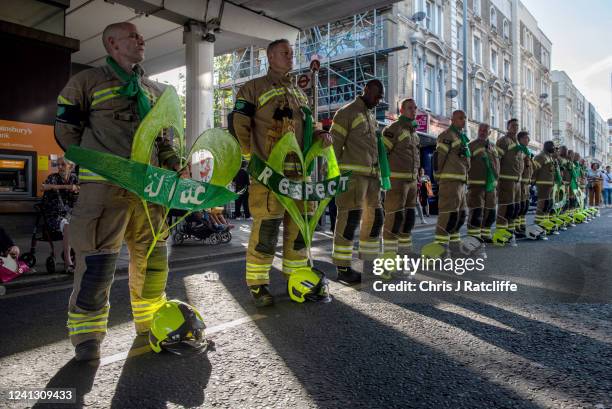 Fire fighters line Ladbroke Grove, near Grenfell Tower, during a silent walk to remember five years since the Grenfell Tower fire on June 14, 2022 in...