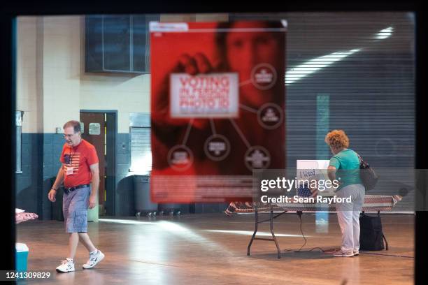 Woman stands at a voting machine during midterm primary elections on June 14, 2022 in West Columbia, South Carolina. Maine, Nevada and North Dakota...