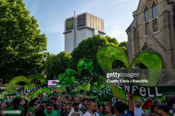 Members of the local community take part in a silent walk to remember five years since the Grenfell Tower fire on June 14, 2022 in London, England....