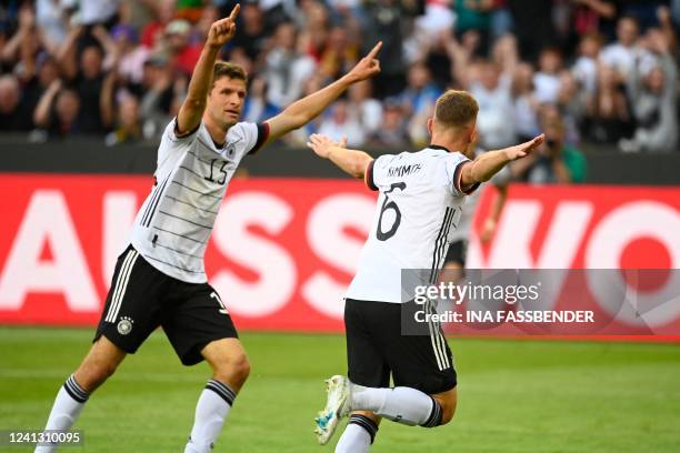 Germany's midfielder Joshua Kimmich celebrates scoring the opening goal with Germany's forward Thomas Mueller during the UEFA Nations League football...