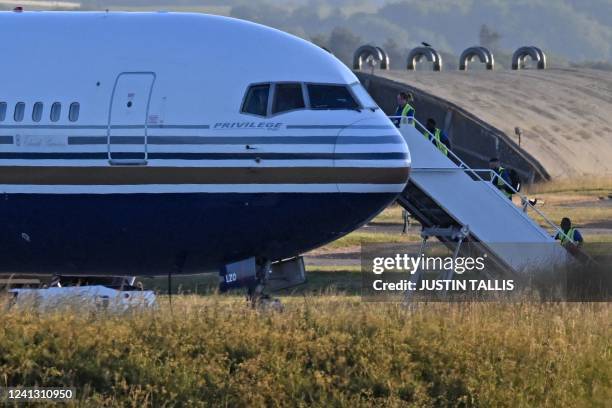 Boeing 767 sits on the runway at the military base in Amesbury, Salisbury, on June 14 preparing to take a number of asylum-seekers to Rwanda. - The...