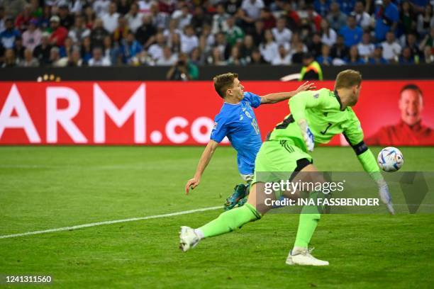 Italy's midfielder Nicolo Barella kicks a goal in offside against Germany's goalkeeper Manuel Neuer during the UEFA Nations League football match...