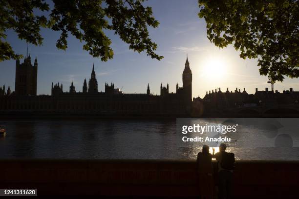 The Palace of Westminster and Big Ben cast bright silhouettes on the horizon during sunset in London, United Kingdom on June 14, 2022.
