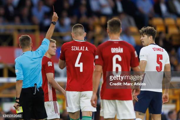 Referee Clement Turpin shows John Stones of England a red card during the UEFA Nations League League A Group 3 match between England and Hungary at...