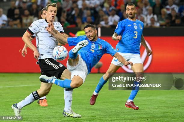 Italy's forward Gianluca Caprari makes a scissor kick next to Germany's defender Lukas Klostermann during the UEFA Nations League football match...