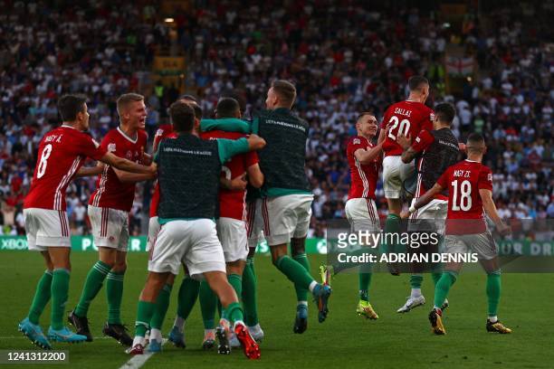Hungary's midfielder Roland Salai celebrates with teammates after scoring their second goal during the UEFA Nations League, league A group 3 football...