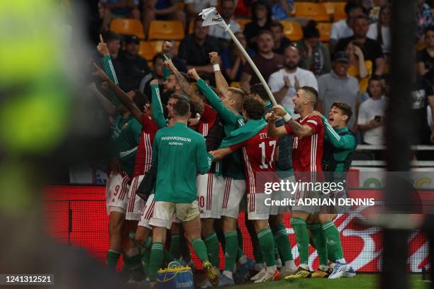 Hungary's midfielder Daniel Gazdag celebrates with teammates after scoring their fourth goal during the UEFA Nations League, league A group 3...