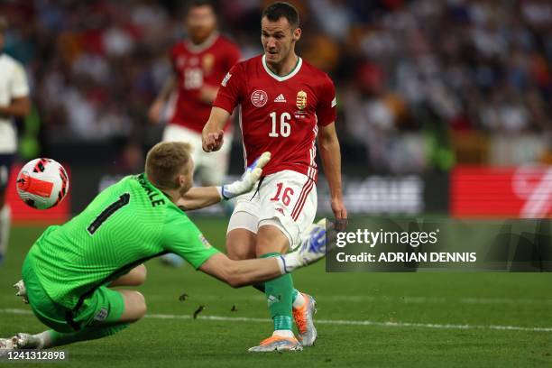 Hungary's midfielder Daniel Gazdag shoots past England's goalkeeper Aaron Ramsdale to score their fourth goal during the UEFA Nations League, league...