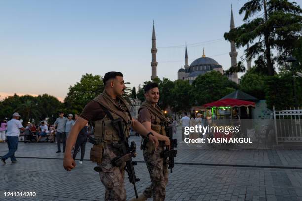 Two Turkish riot police officers walk in front of the Blue Mosque in Istanbul, on June 14, 2022. - Israel's Foreign Minister Yair Lapid urged...