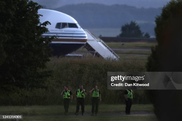 Police officers patrol the grounds around the Rwanda deportation flight EC-LZO Boeing 767 at Boscombe Down Air Base, on June 14, 2022 in Boscombe...