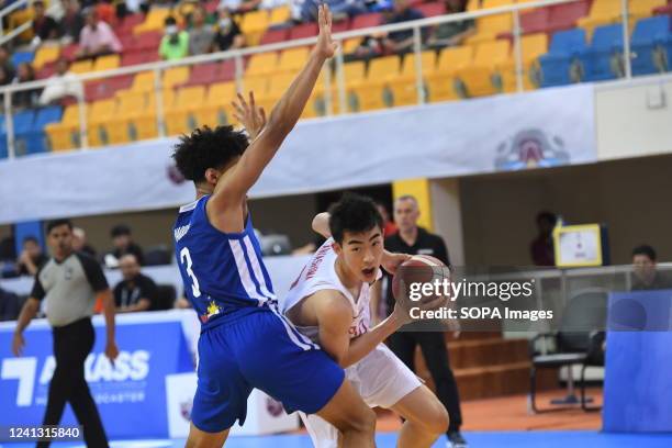 Sebastian Roy Reyes of the Philippine Basketball team and Yuto Kawashima of the Japan Basketball team in action during the 2022 FIBA U16 Asian...