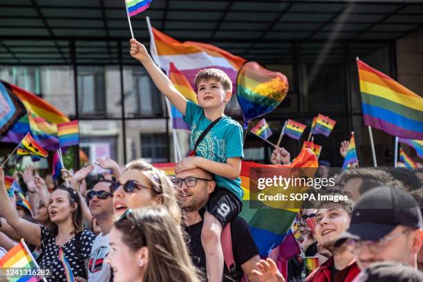 Young boy carried on his father shoulders waves a pride flag during the Pride rally. The 14th pride procession was held Wroclaw. It was focused not...