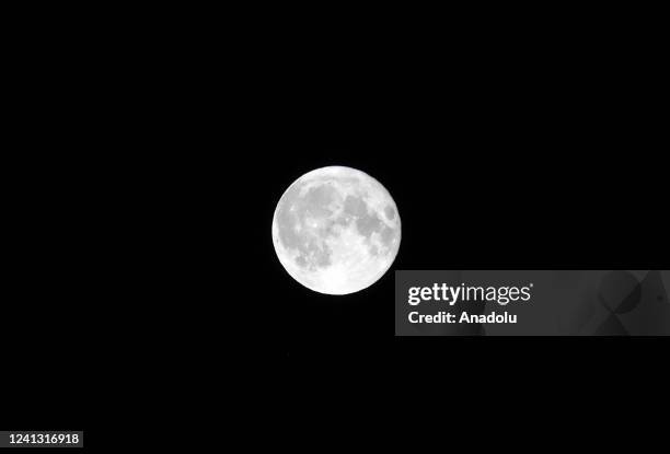 Full moon, known as the Strawberry moon rises over the sky in Brussels, Belgium on June 15, 2022.