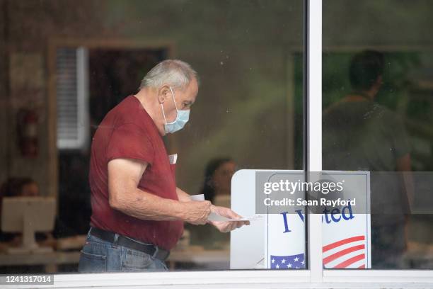 Man holds his ballot after voting in midterm primary elections on June 14, 2022 in West Columbia, South Carolina. Maine, Nevada and North Dakota also...