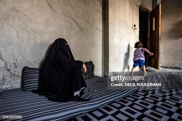 Amal a former detainee at the Kurdish-run al-Hol camp where relatives of suspected Islamic State group fighters were held, gives an interview at her...