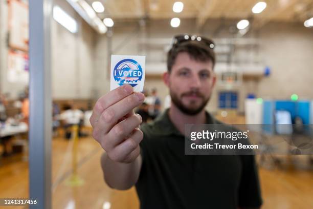Voter shows off his, "I voted" sticker after casting a ballot in the Nevada primary on June 14, 2022 in Reno, Nevada. The Nevada primary is...