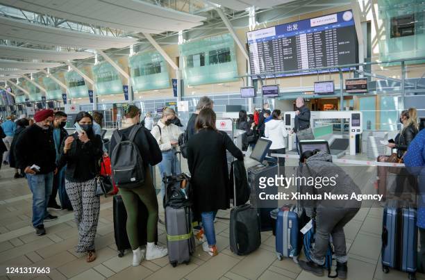 Travelers line up to check in at Vancouver International Airport in Richmond, British Columbia, Canada, on June 14, 2022. The Canadian federal...