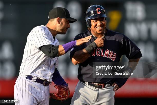 Colorado Rockies shortstop Jose Iglesias and Cleveland Guardians third baseman Jose Ramirez have a word at second base after Ramirez doubled in the...